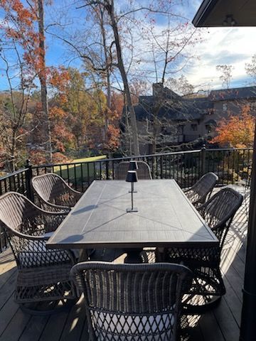 There is a table and chairs on the deck.