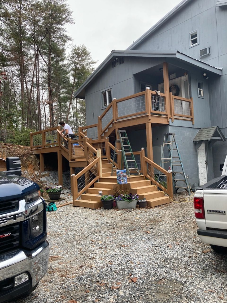 A house with a large wooden deck in front of it