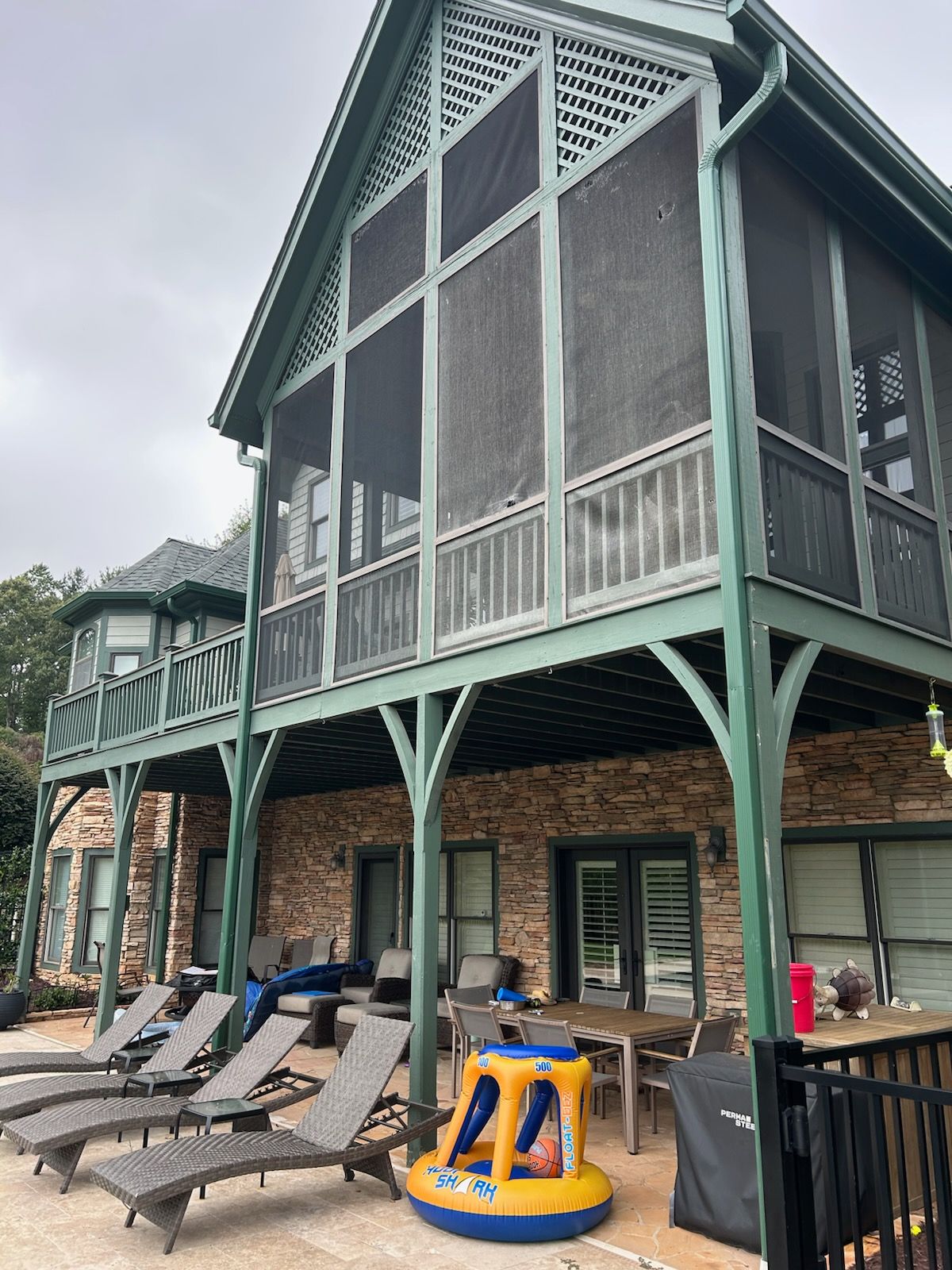 There is a grill on the porch of a house.