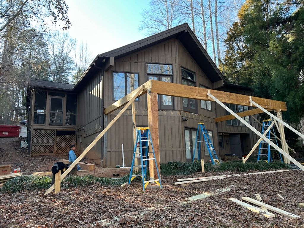 There is a grill on the porch of a house.