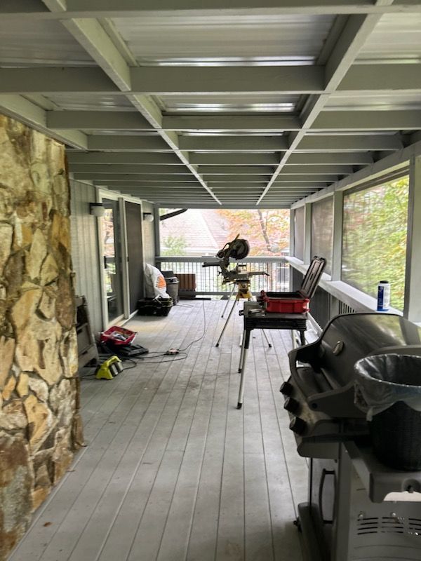 There is a grill on the porch of a house.