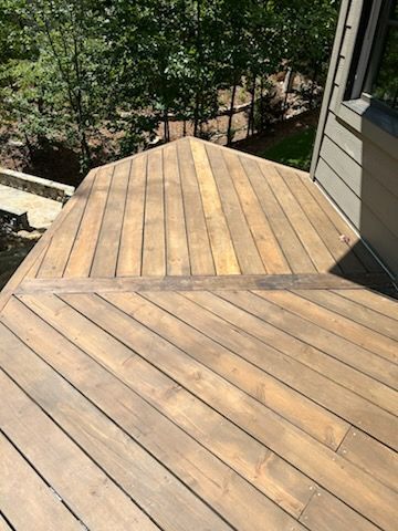 A wooden deck with a staircase leading up to it.