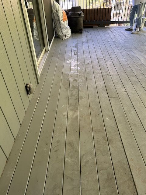 A wooden deck with a bag of dirt on it.