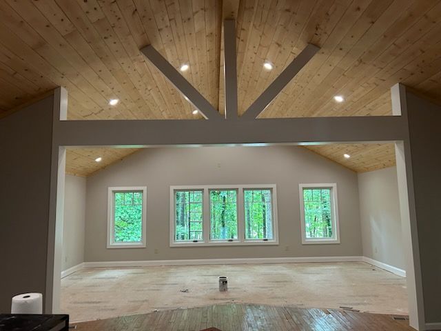 A wooden deck with stairs leading up to a concrete walkway.