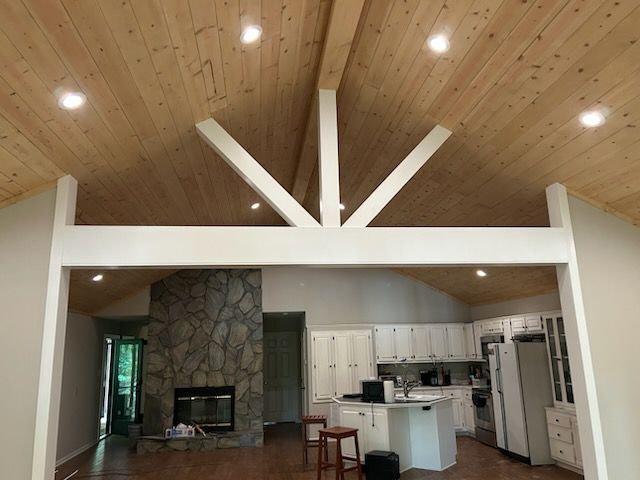 A long gray deck with a stone wall in the background.