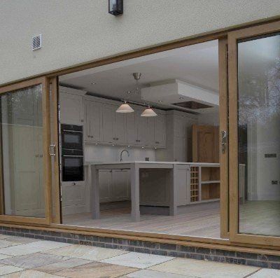 A kitchen with sliding glass doors leading into it