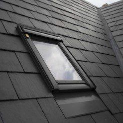 There is a skylight on the roof of a house.
