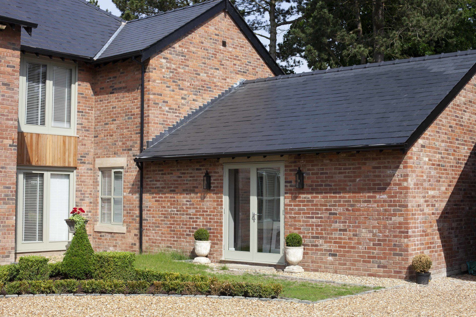 A large red brick house with a blue roof