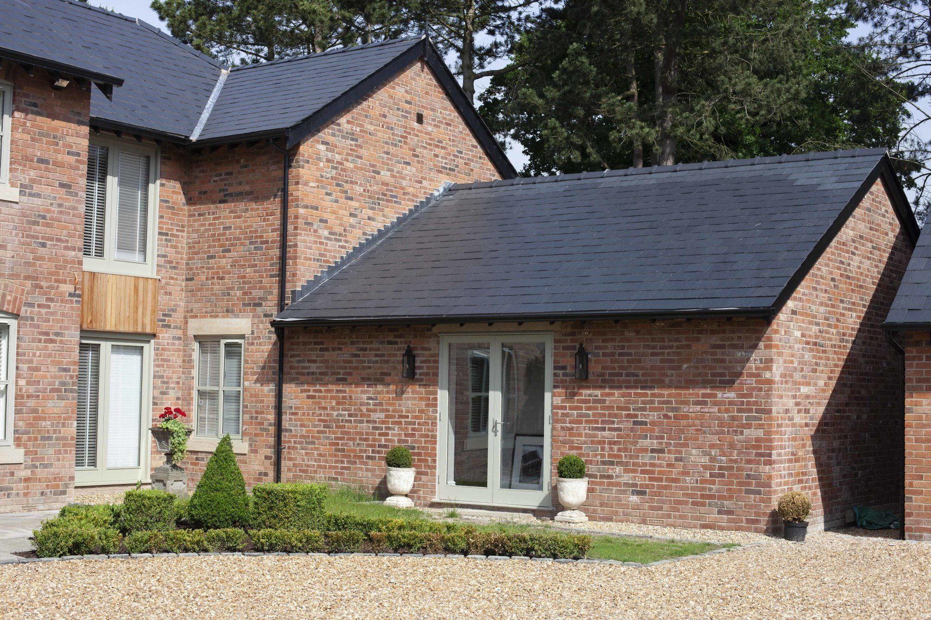 A large brick house with a black roof