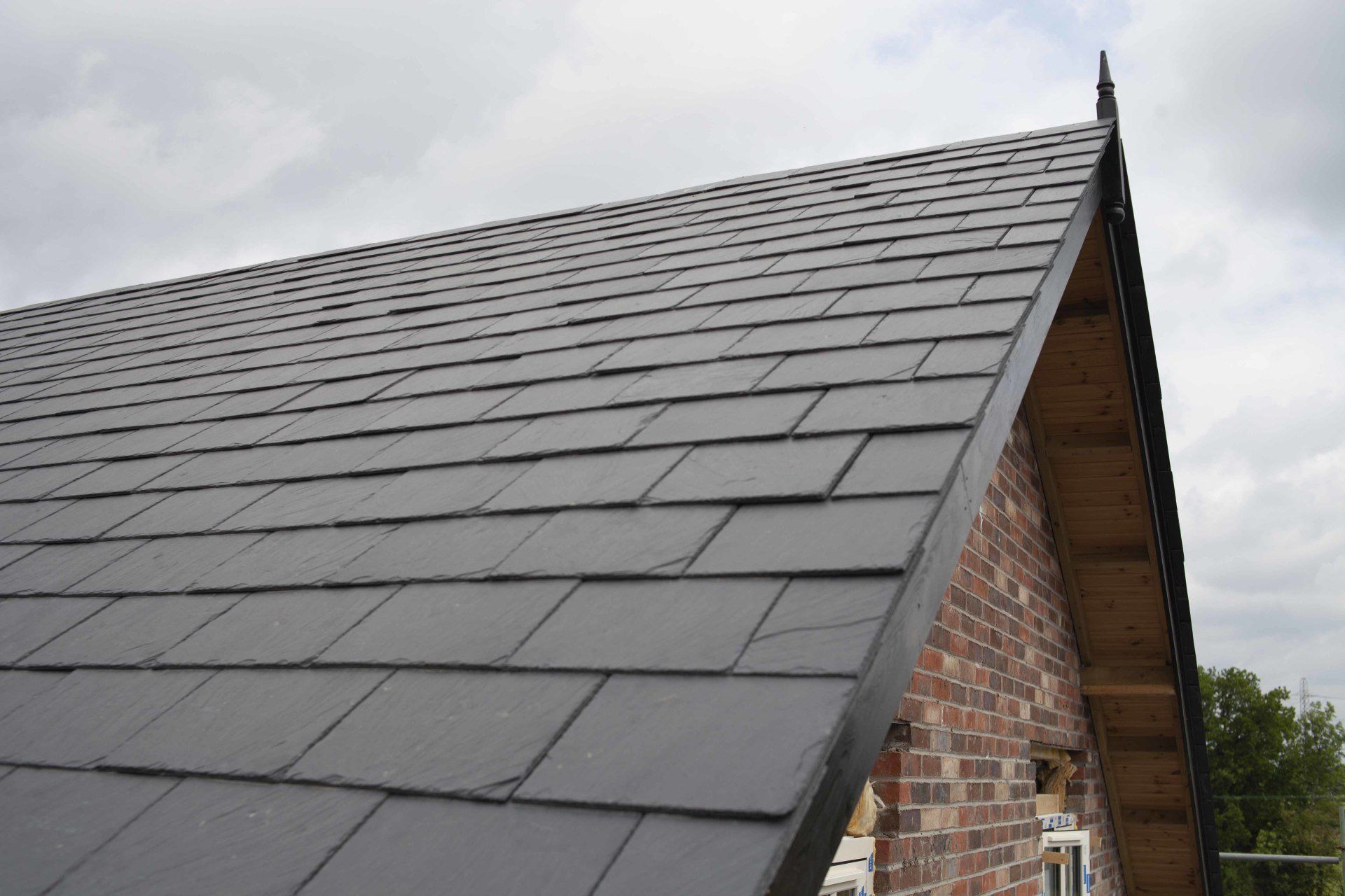 The roof of a brick building with a slate roof