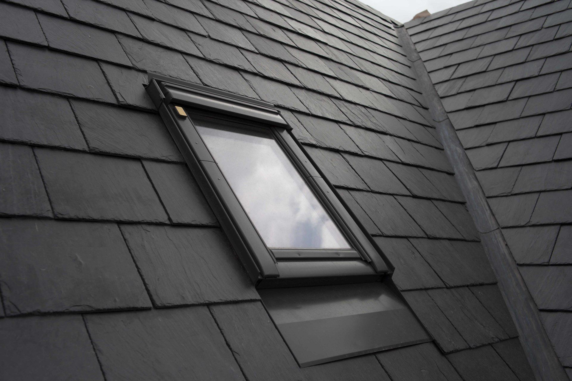 A black roof with a skylight on it