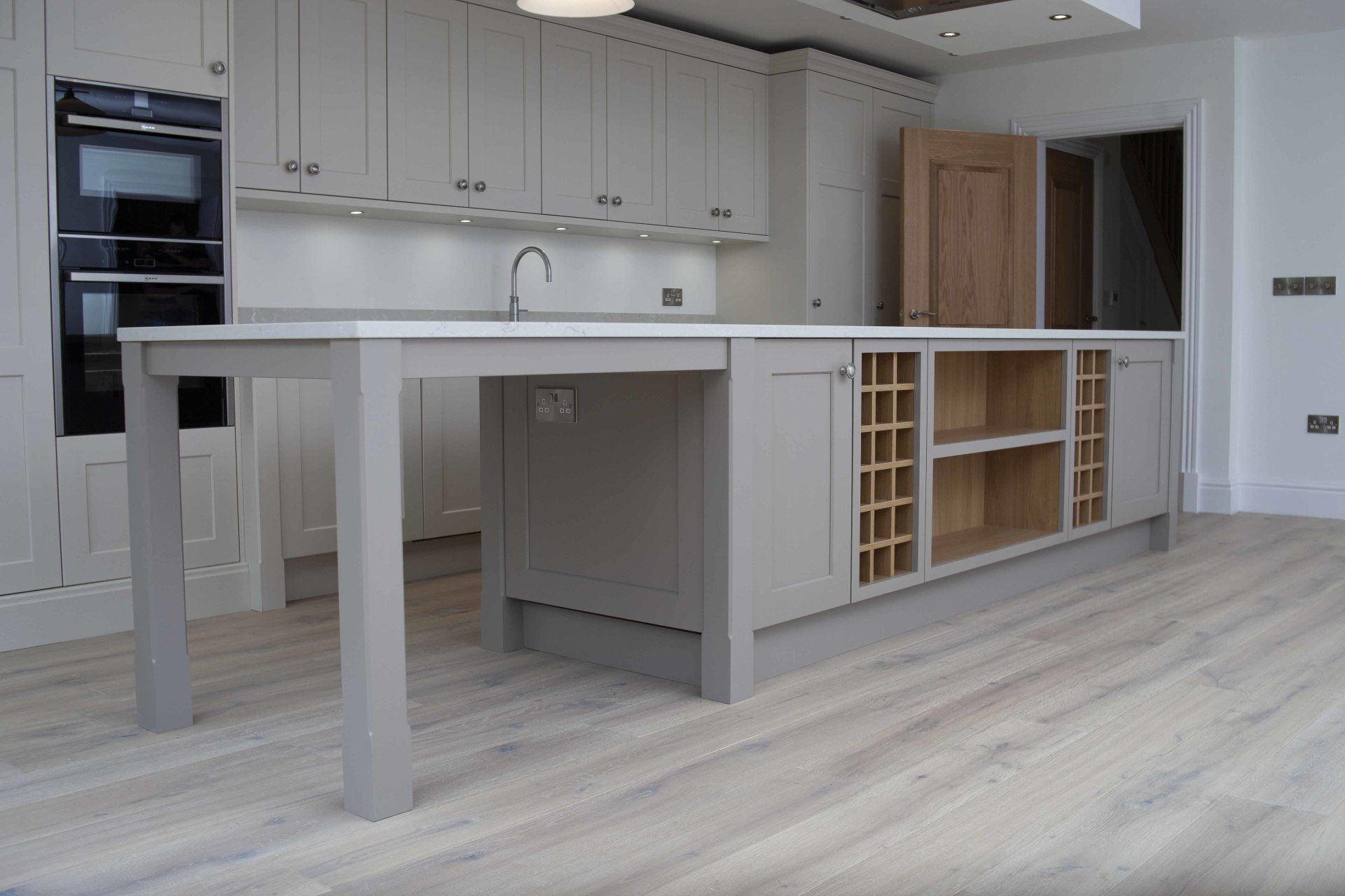 An empty kitchen with a large island in the middle