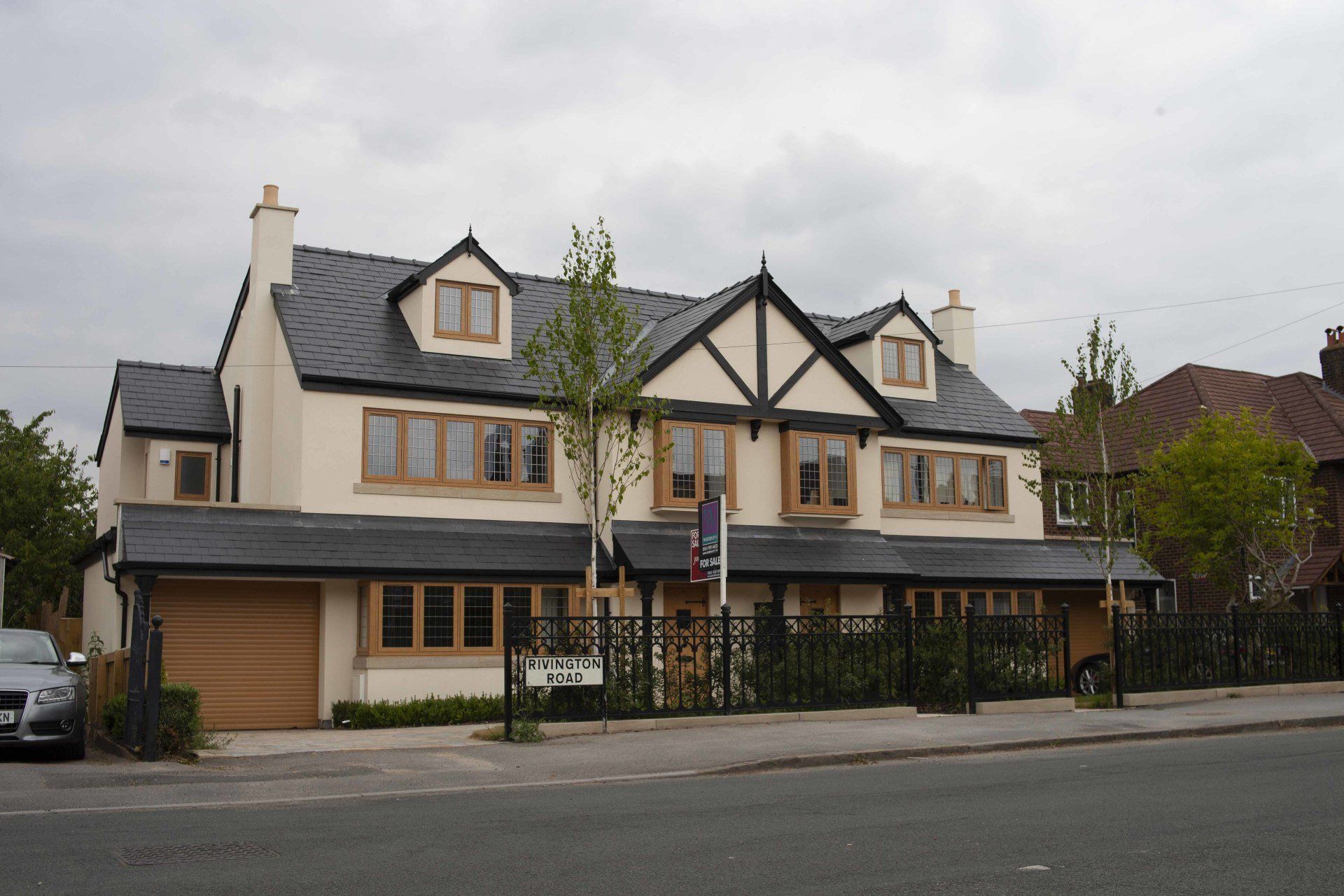 A large white house with a car parked in front of it