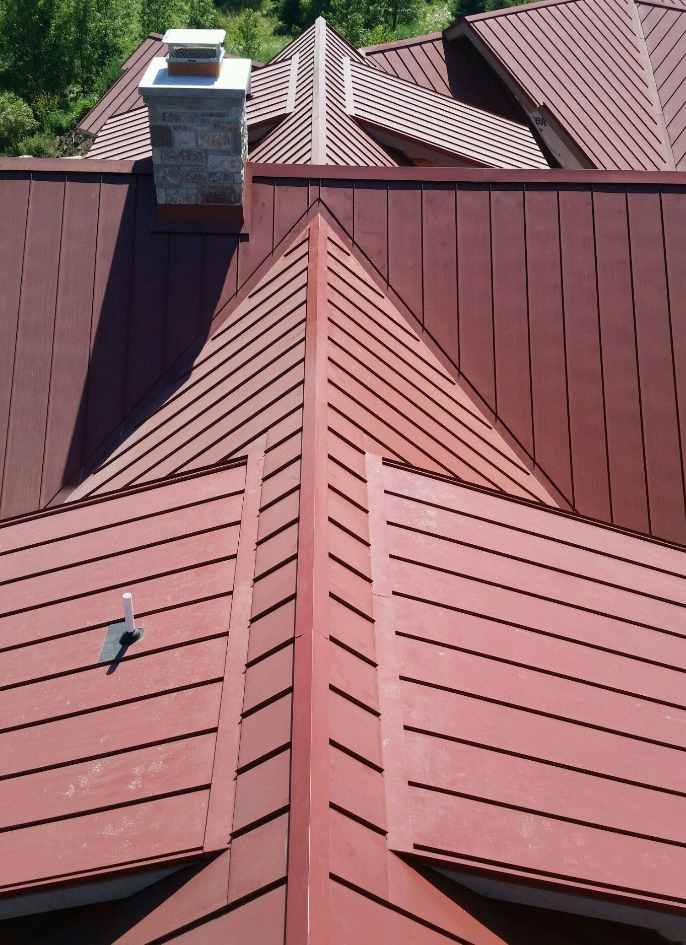 A red roof with a chimney on top of it