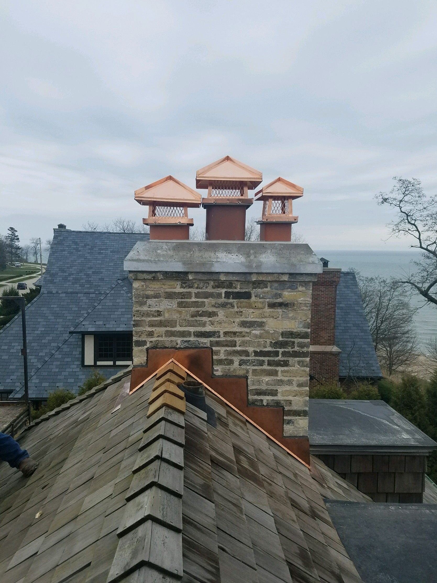 A brick chimney on the roof of a house