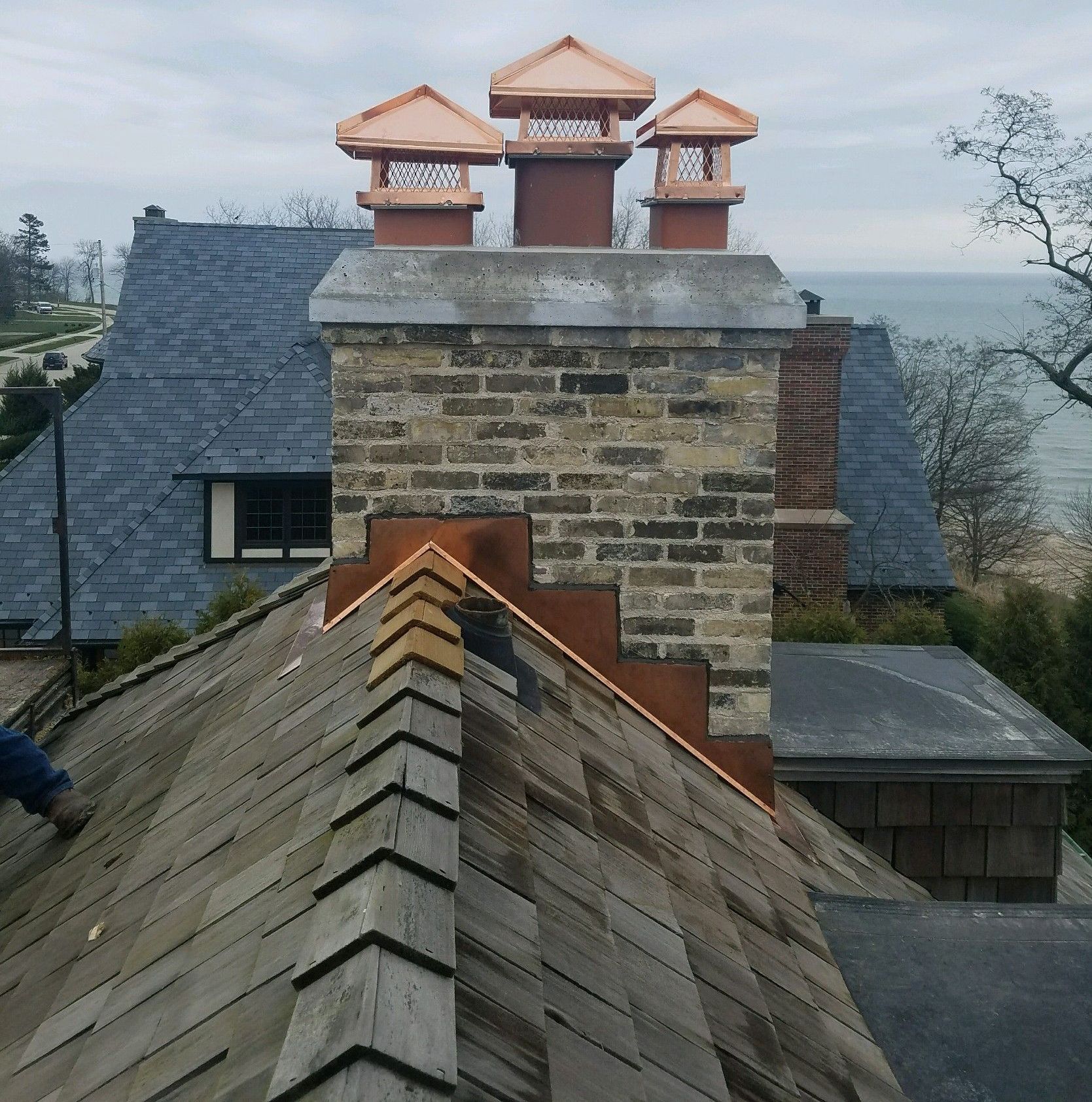 A brick chimney on top of a wooden roof