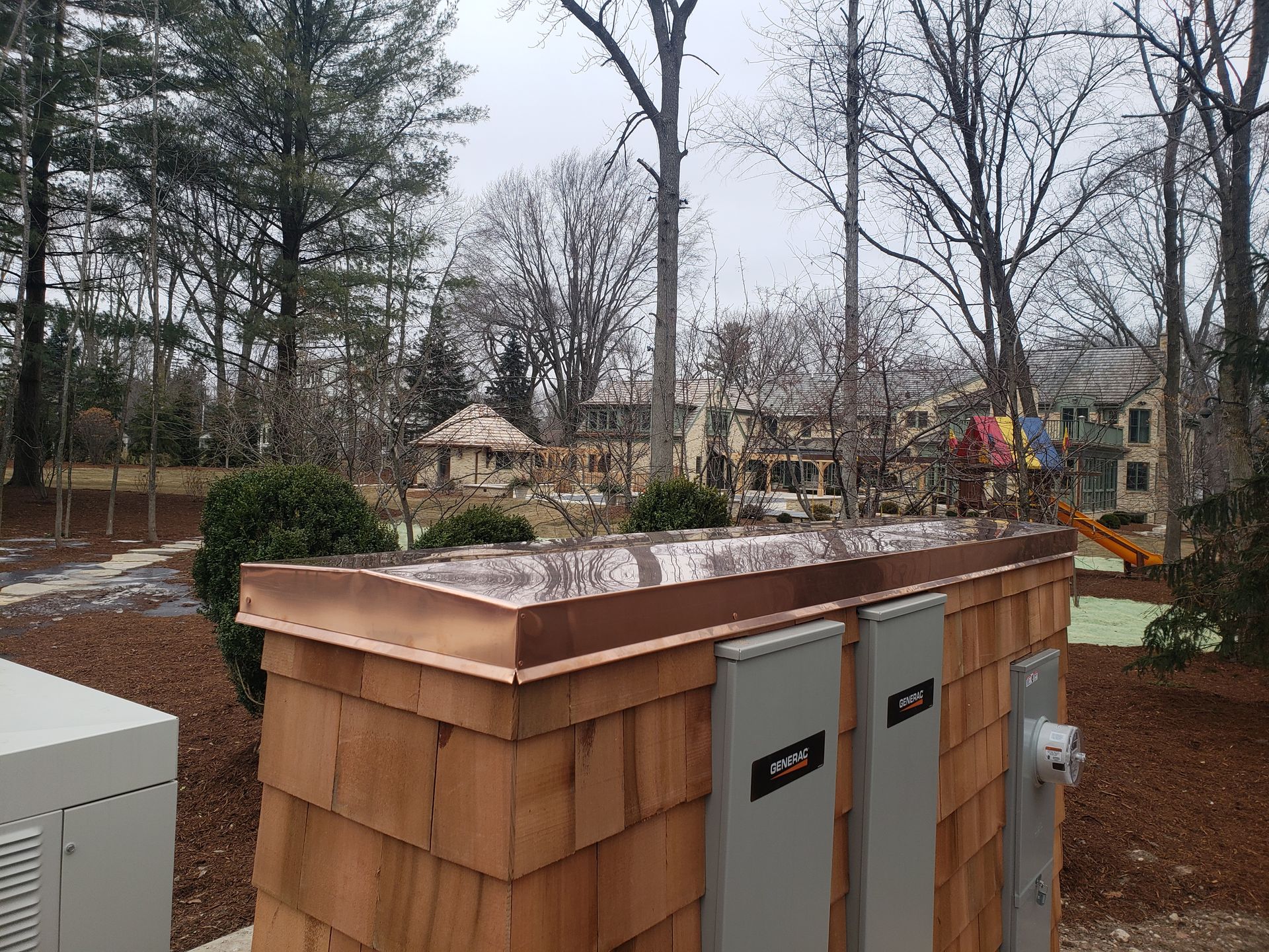 A balcony with a copper roof and a stone ledge