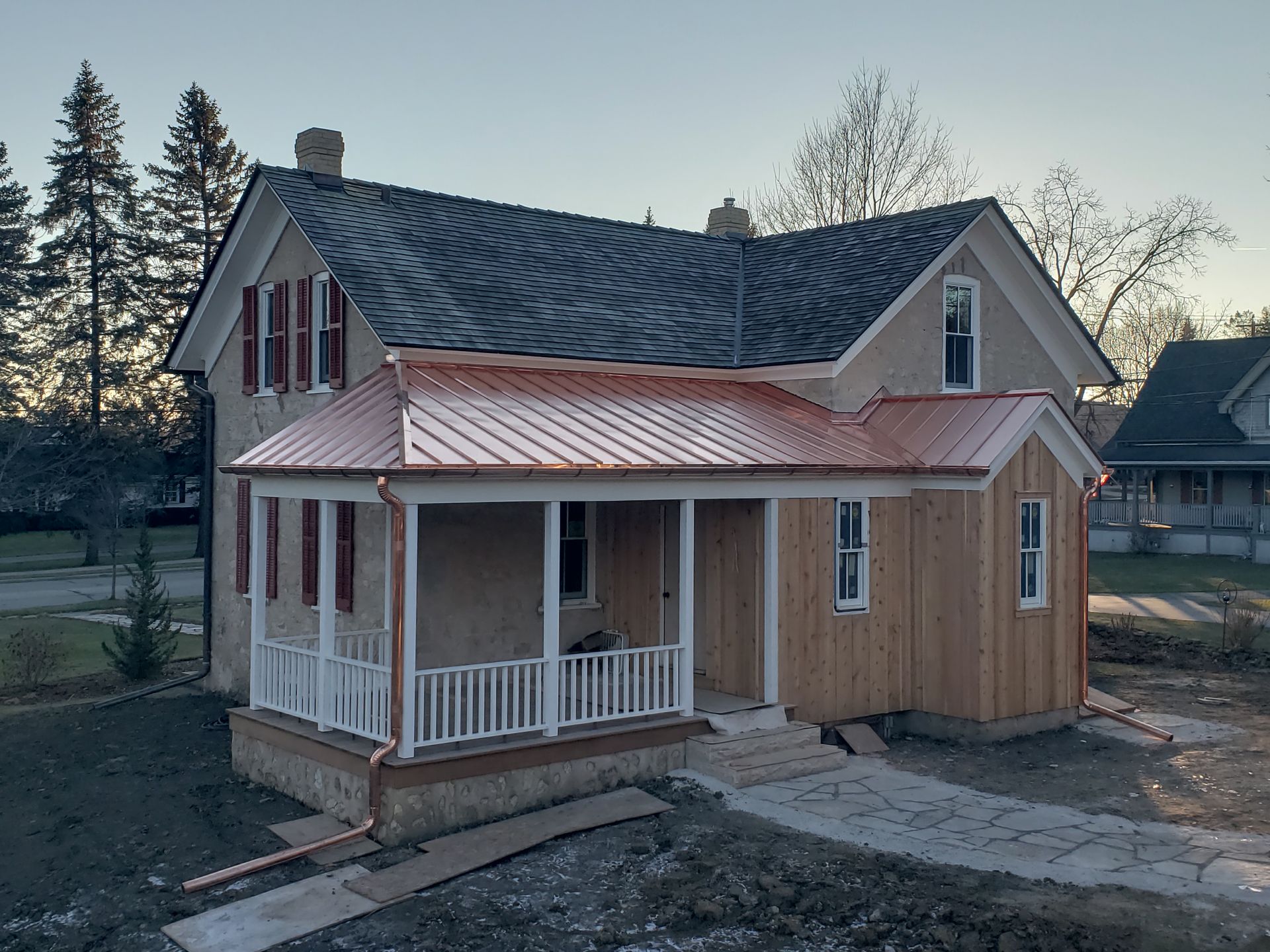 A house with a porch and a copper roof