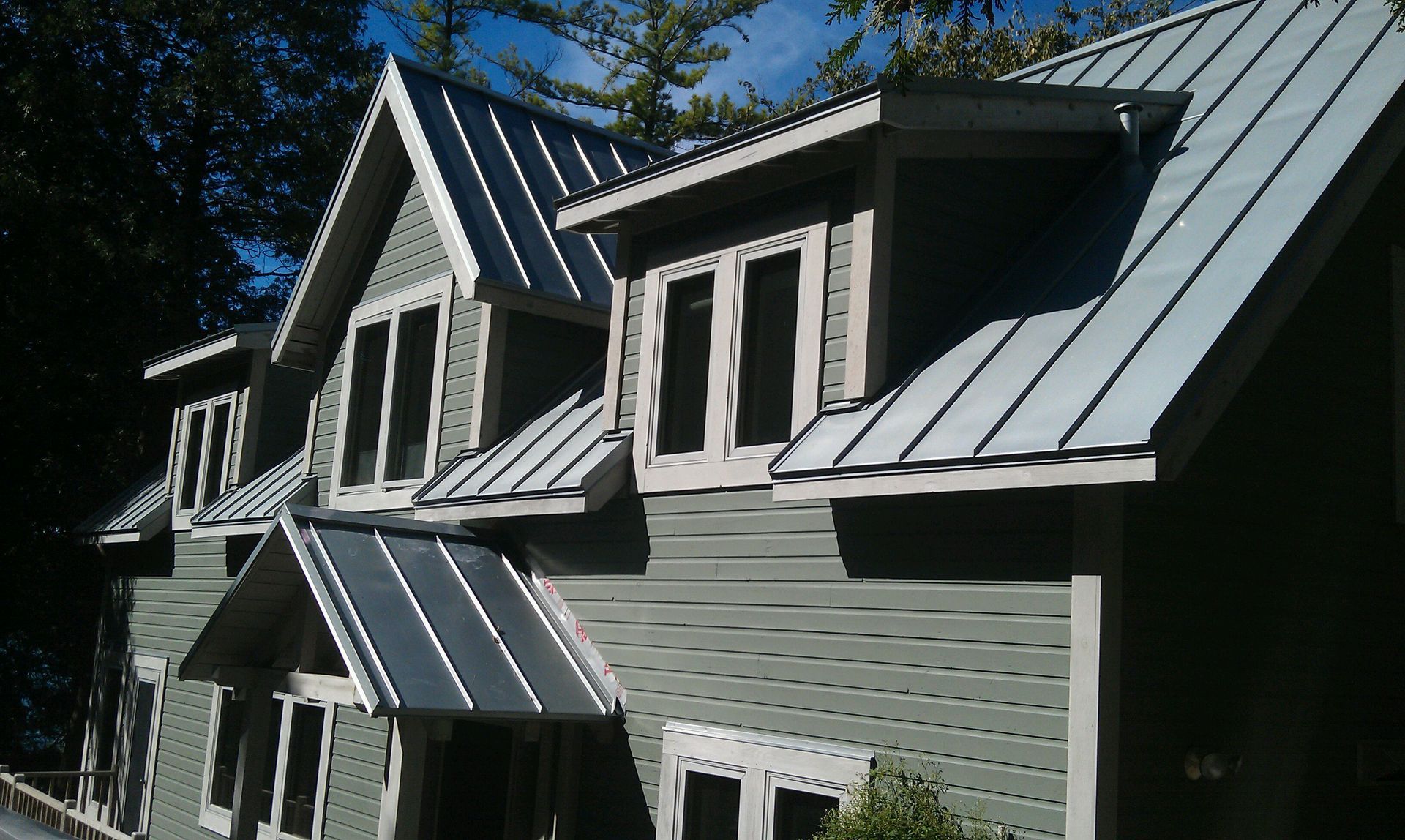 A house with a metal roof and a lot of windows