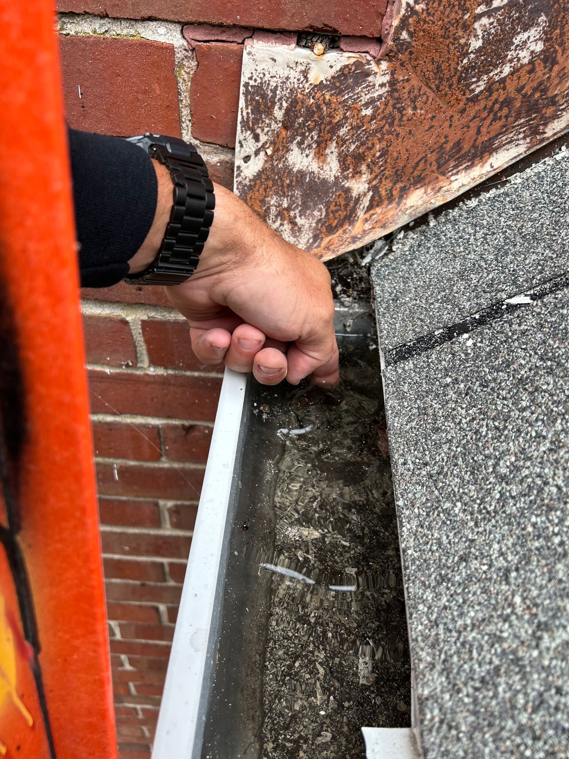 An employee of Moore Quality Exteriors doing an initial preventative maintenance inspection pointing