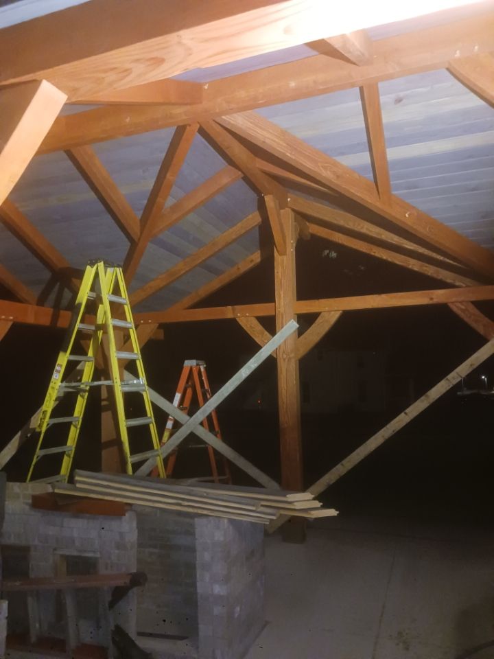 A yellow ladder sits in the middle of a wooden structure