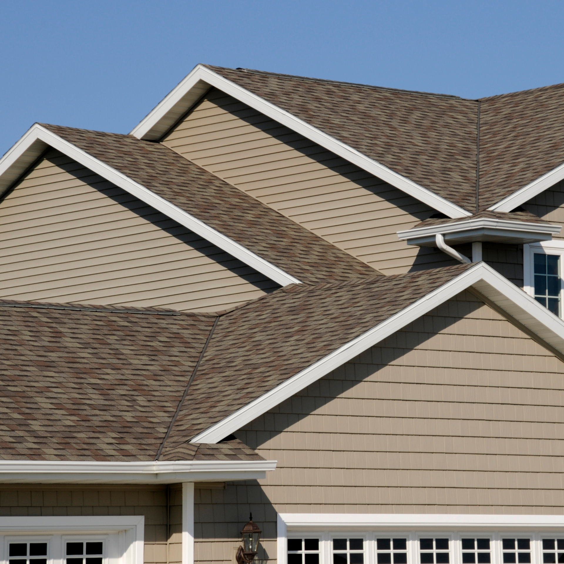 A house with a brown roof and white trim