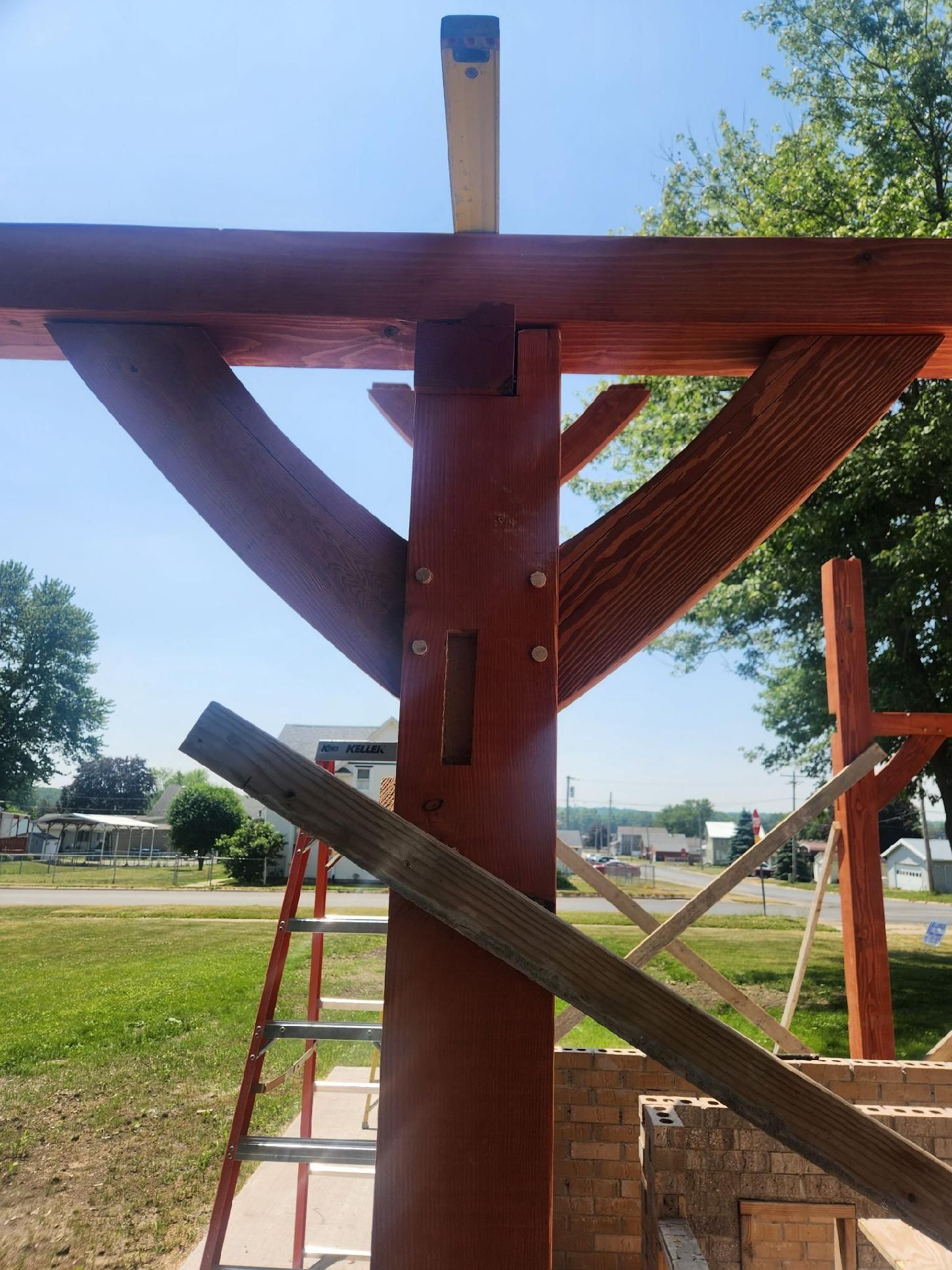 A wooden structure is being built with a ladder in the foreground.