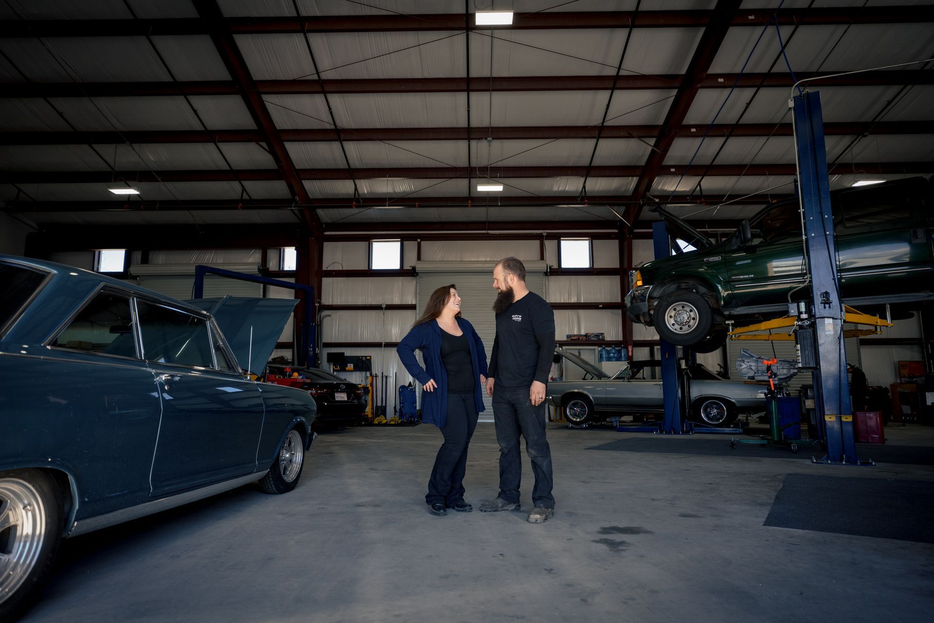 Owners together inside garage | Shift'N Gears Auto Repair