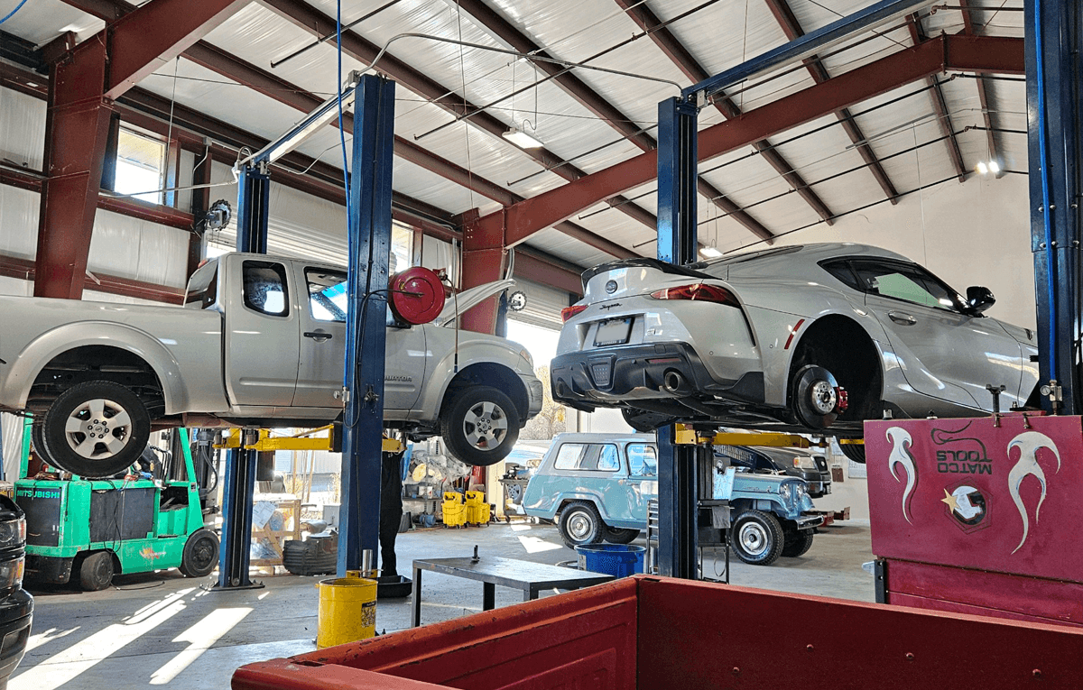 Car Lifted in Garage | Shift'N Gears Auto Repair