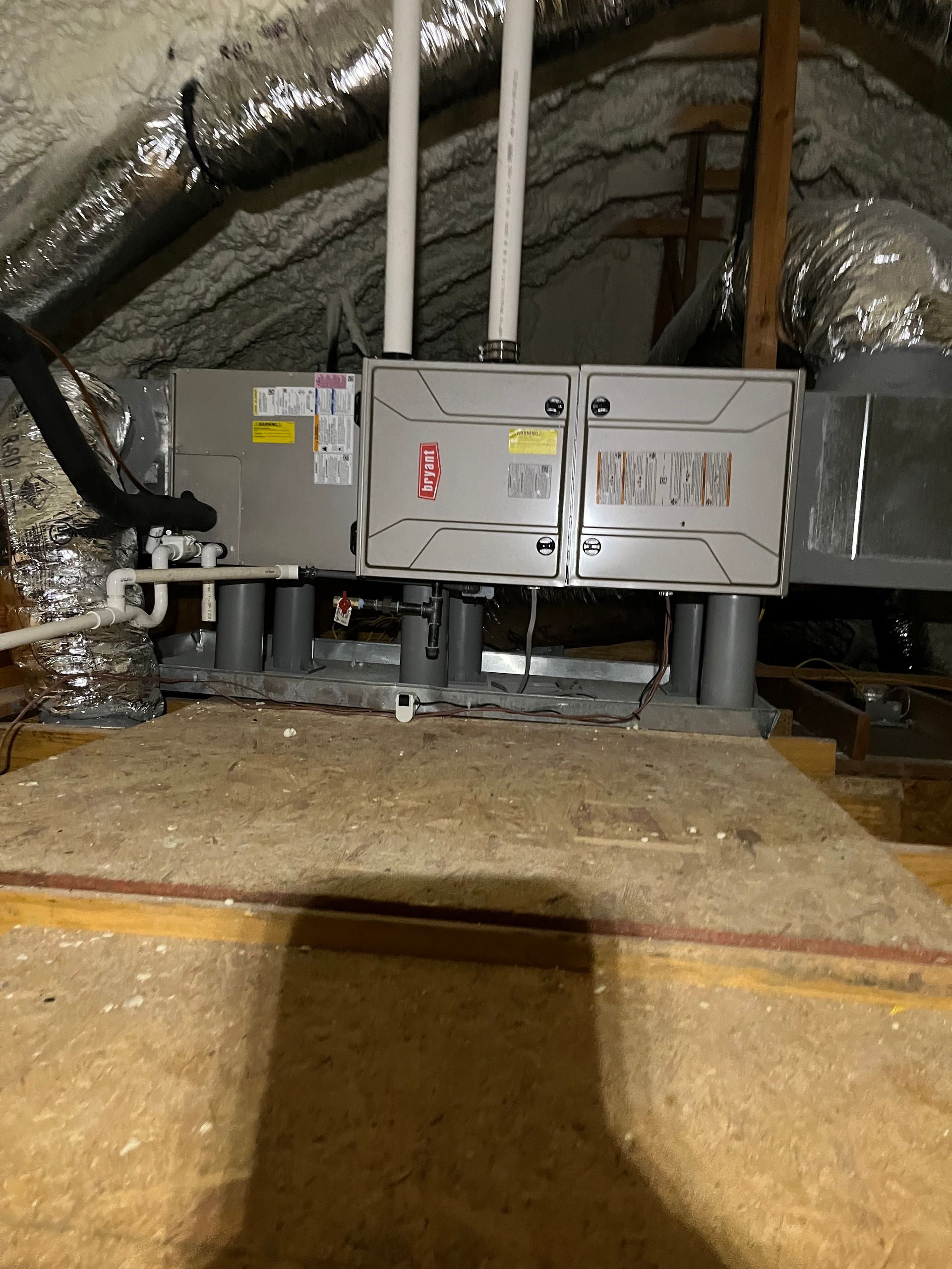 An air conditioner is installed in the attic of a house.