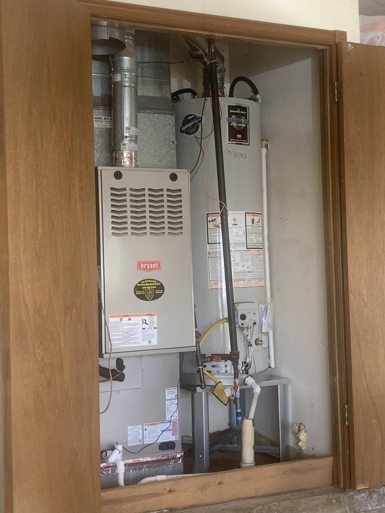 A closet with a furnace and water heater inside of it
