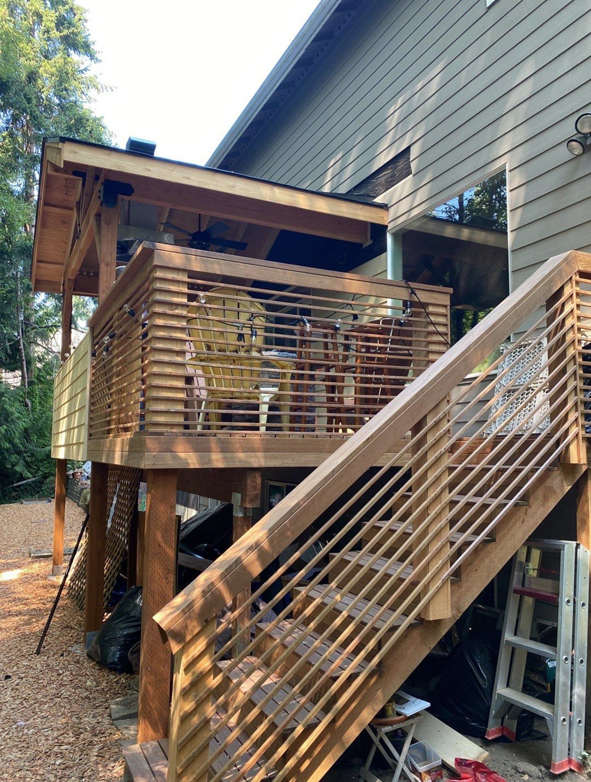 A wooden deck with stairs leading up to it