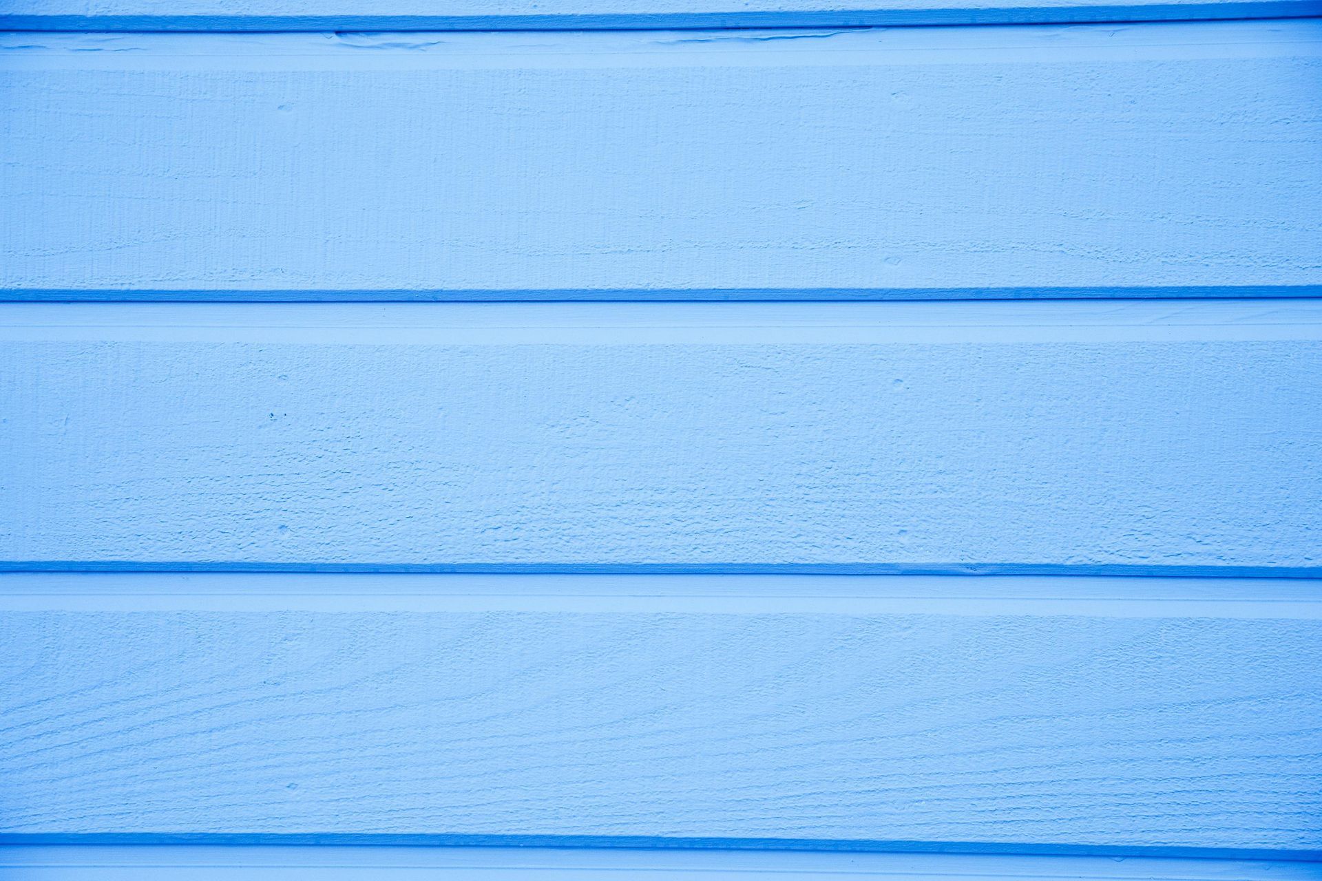 It is a close up of a blue wooden wall.