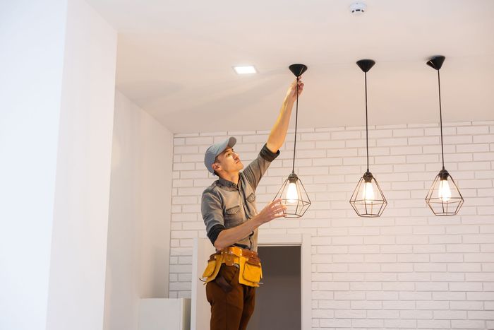 A group of people are holding up their hands with tools.