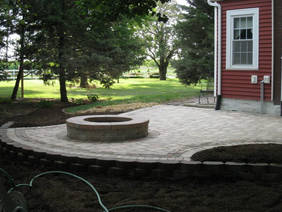 Nice landscape bricking patio with firepit around back of house in Mapleton, IL - Beal Landscaping