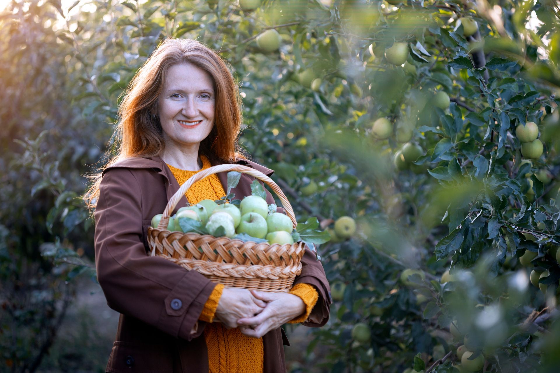 Hand holding silver necklace with a spiral pendant.