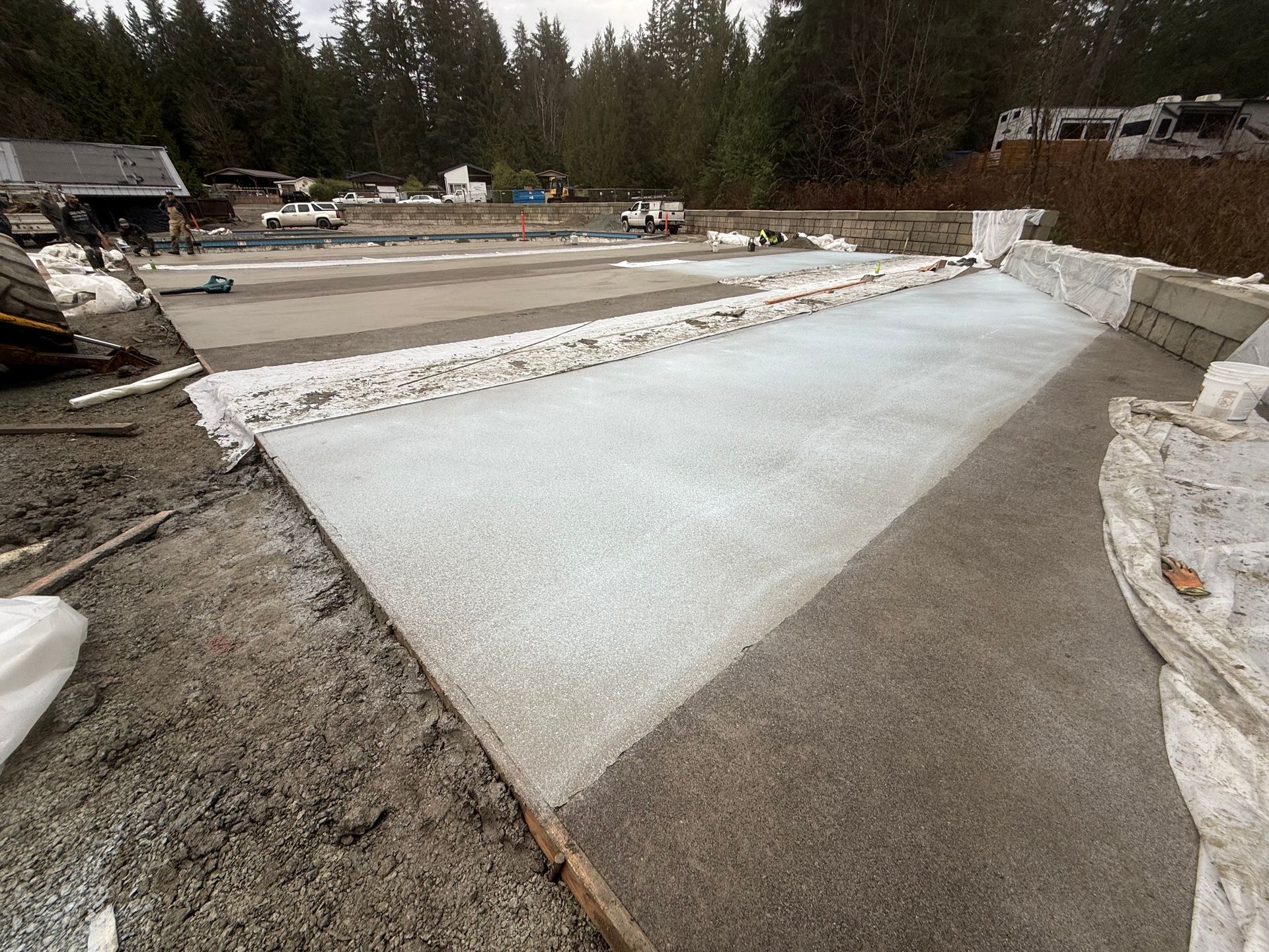 A large piece of concrete is sitting on top of a dirt field.