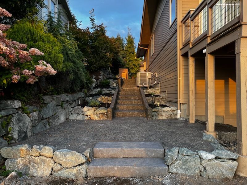 A set of stairs leading up to a house surrounded by rocks.