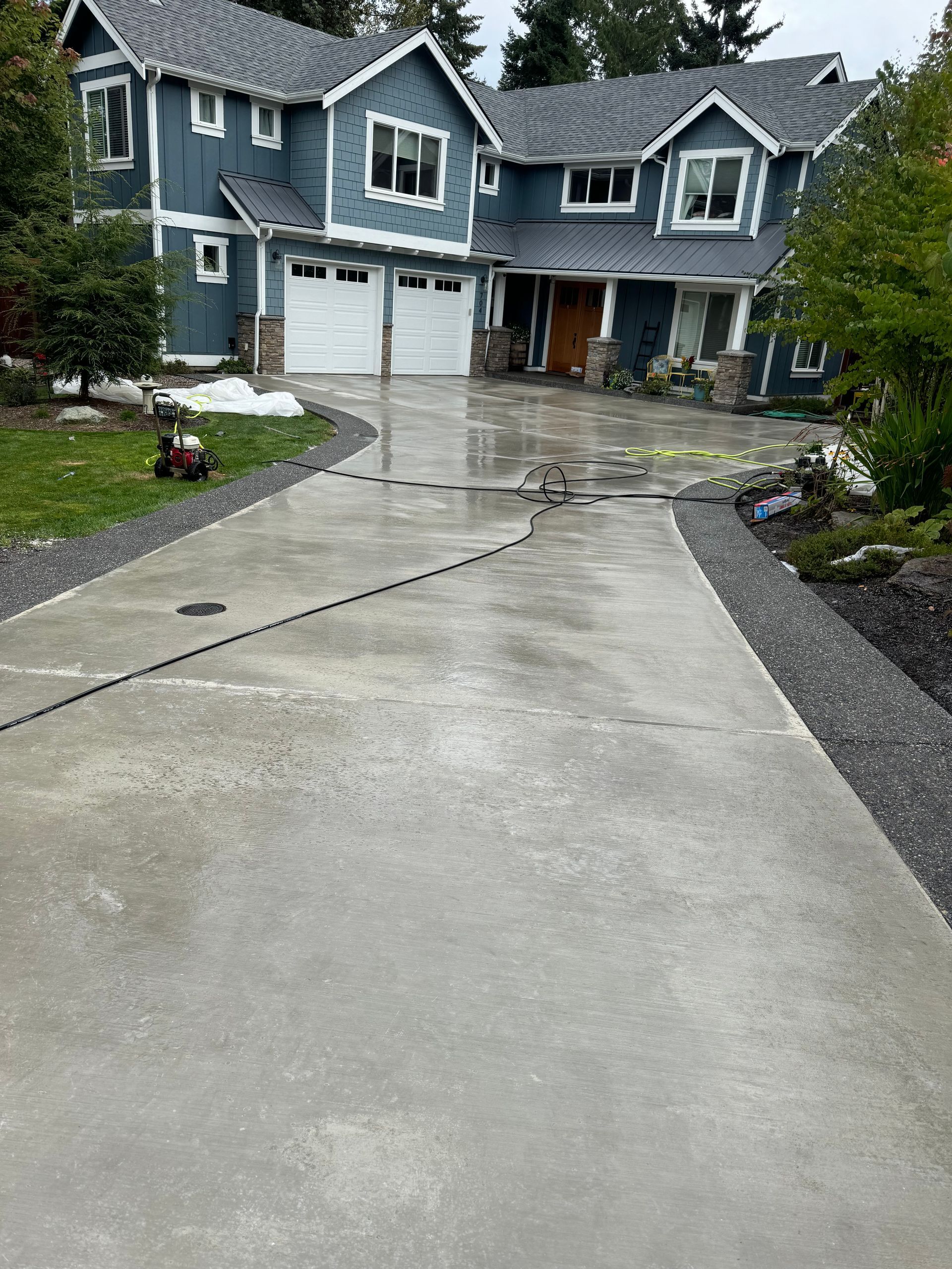 A large house with a concrete driveway in front of it.