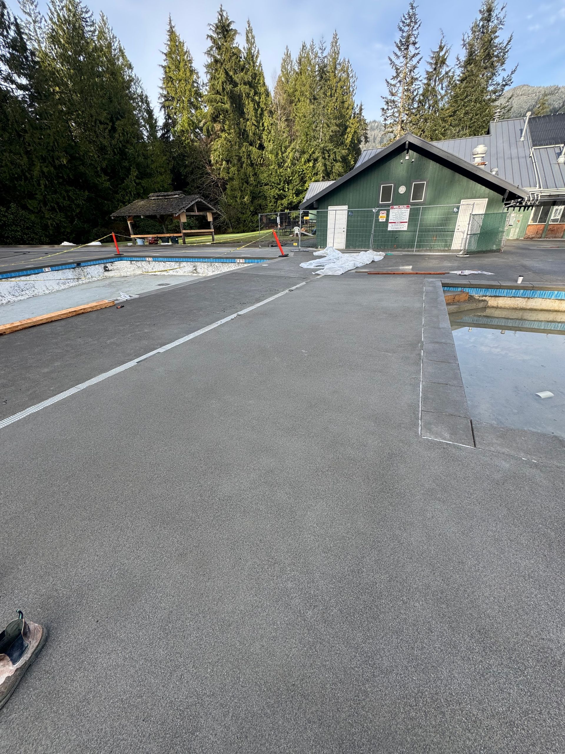 A road with a green building in the background