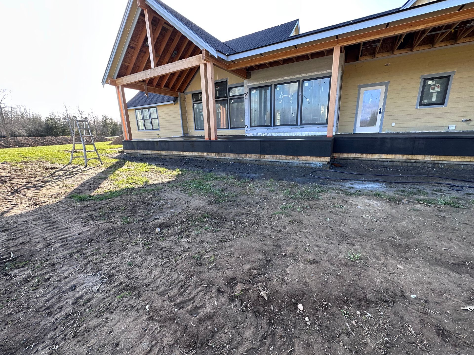 A house is being built in the middle of a dirt field.