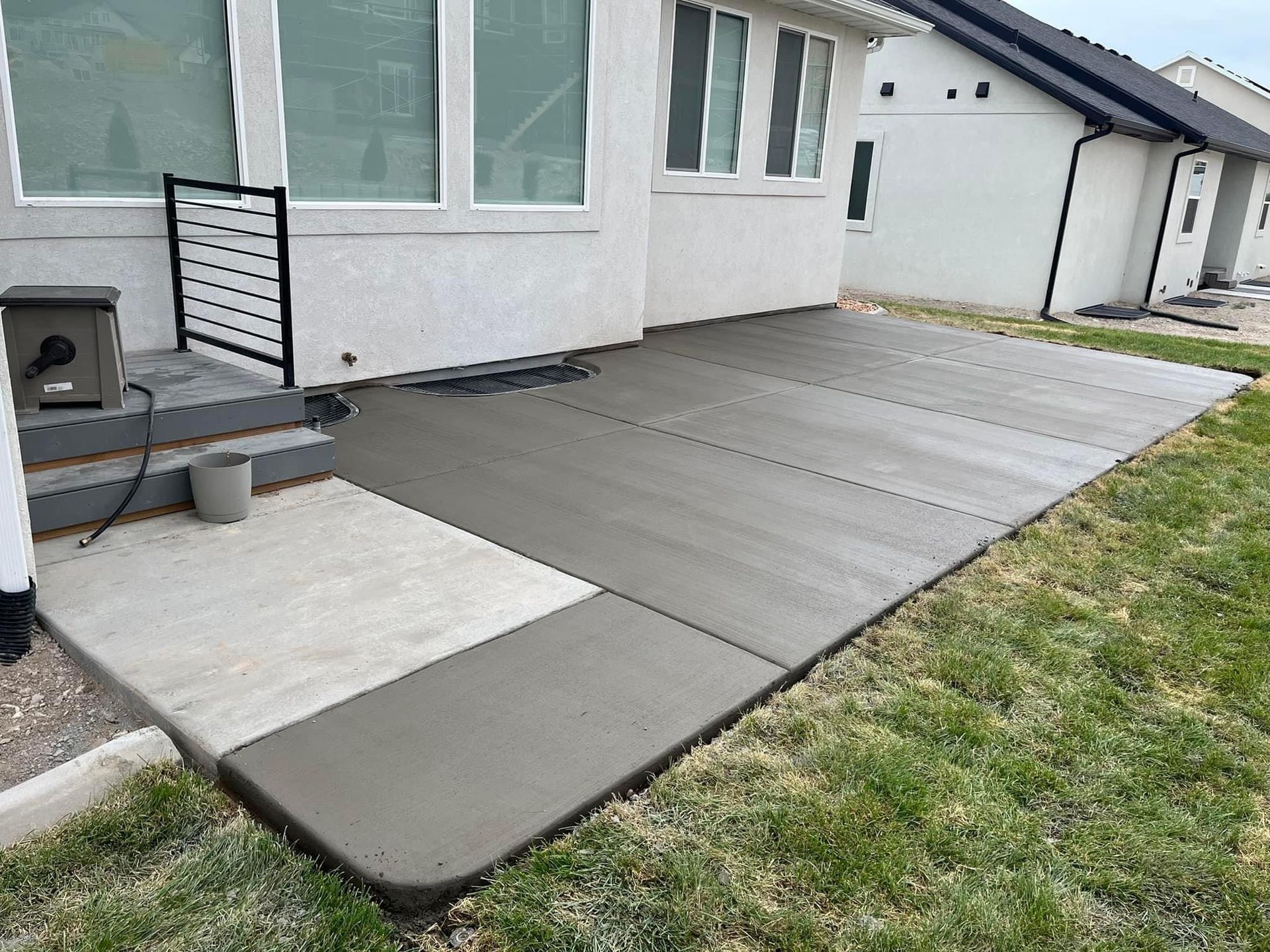 A concrete patio is being built in front of a house.