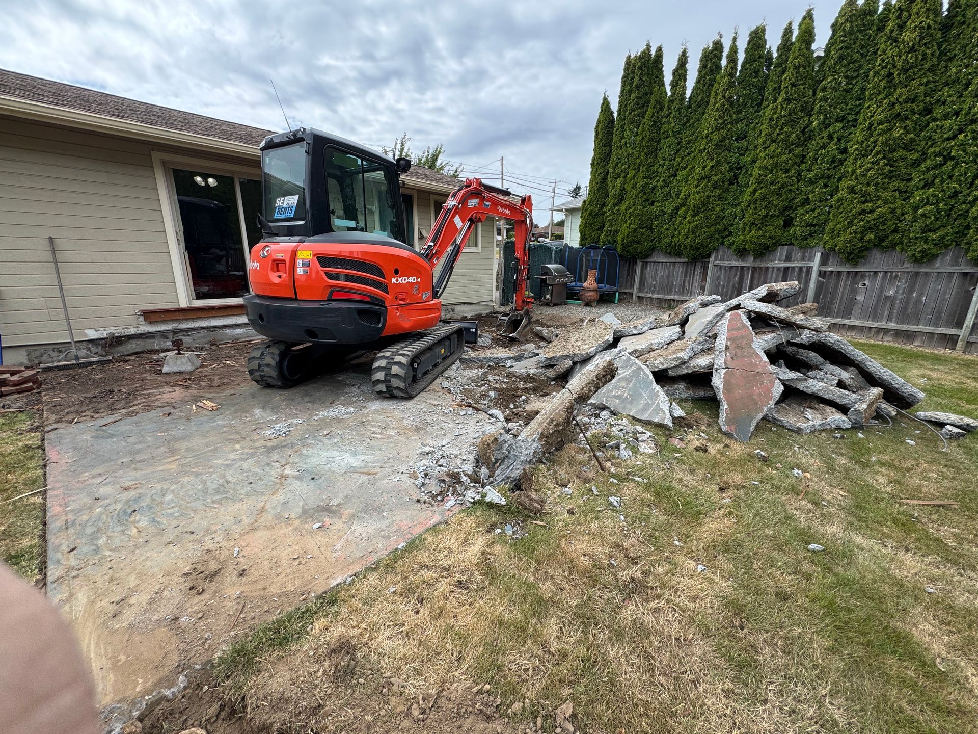 A concrete driveway with a wooden walkway in the middle of it