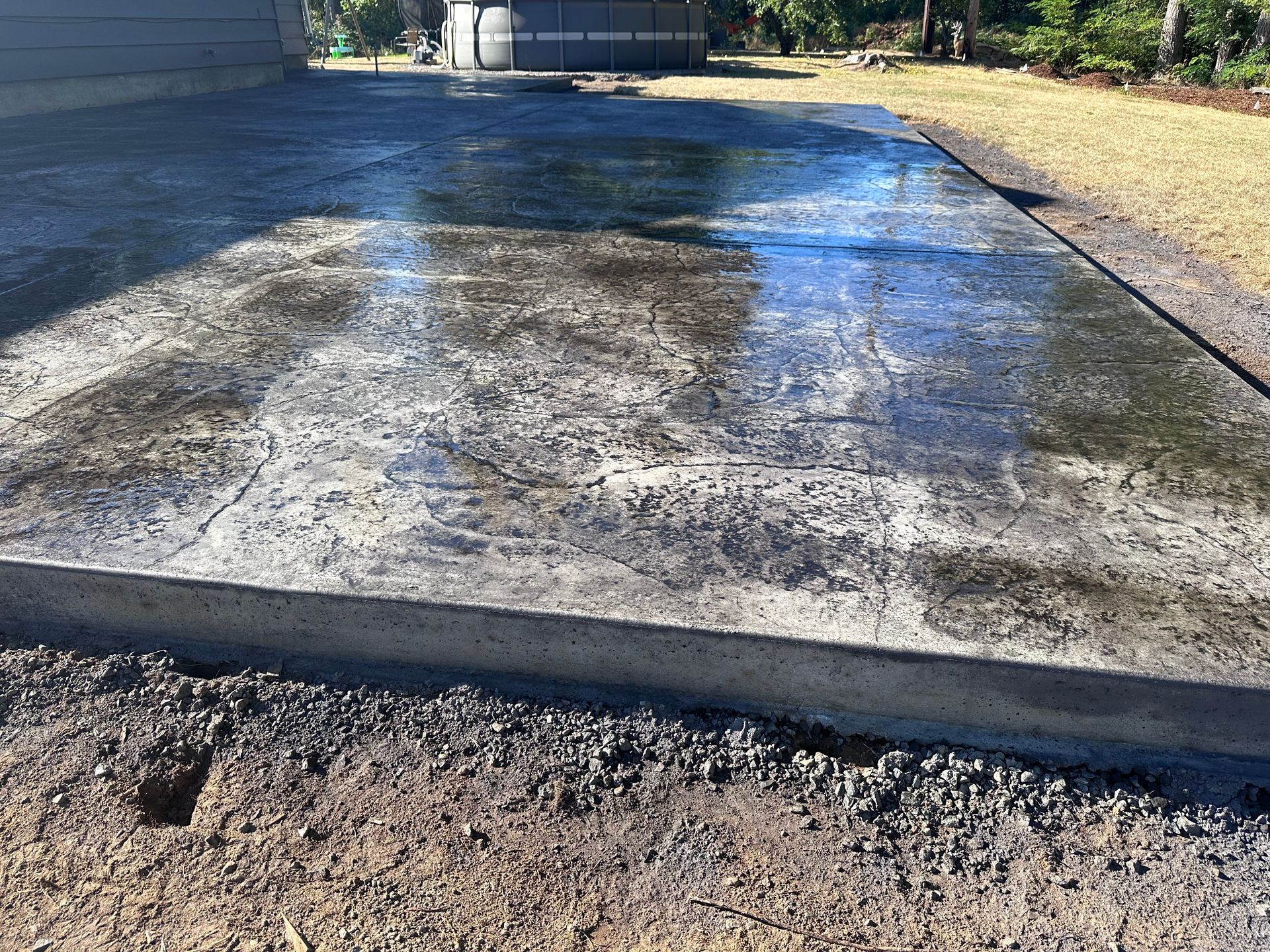 A concrete driveway is being built in front of a house.