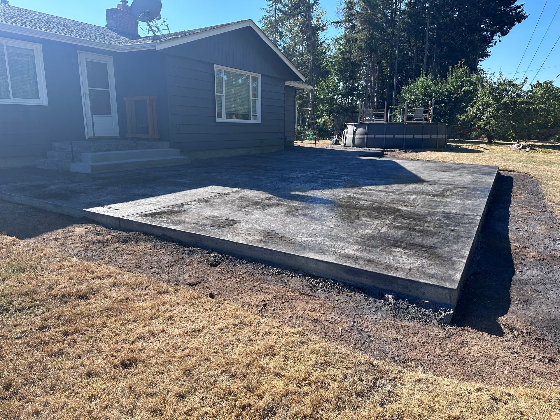 A house with a concrete driveway in front of it.
