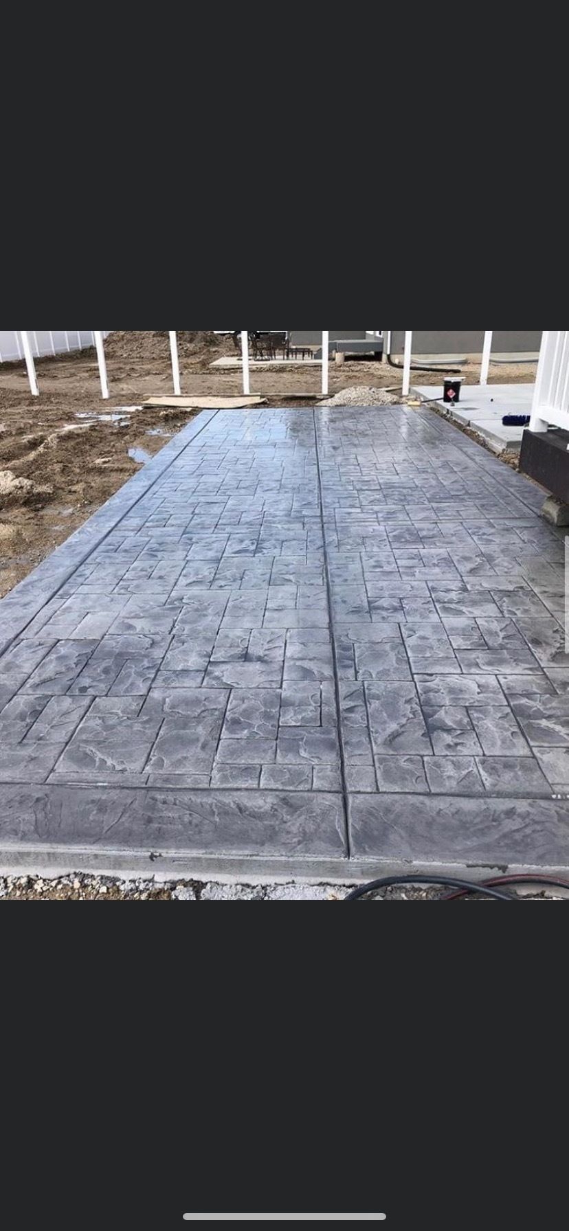 A picture of a concrete driveway being built.