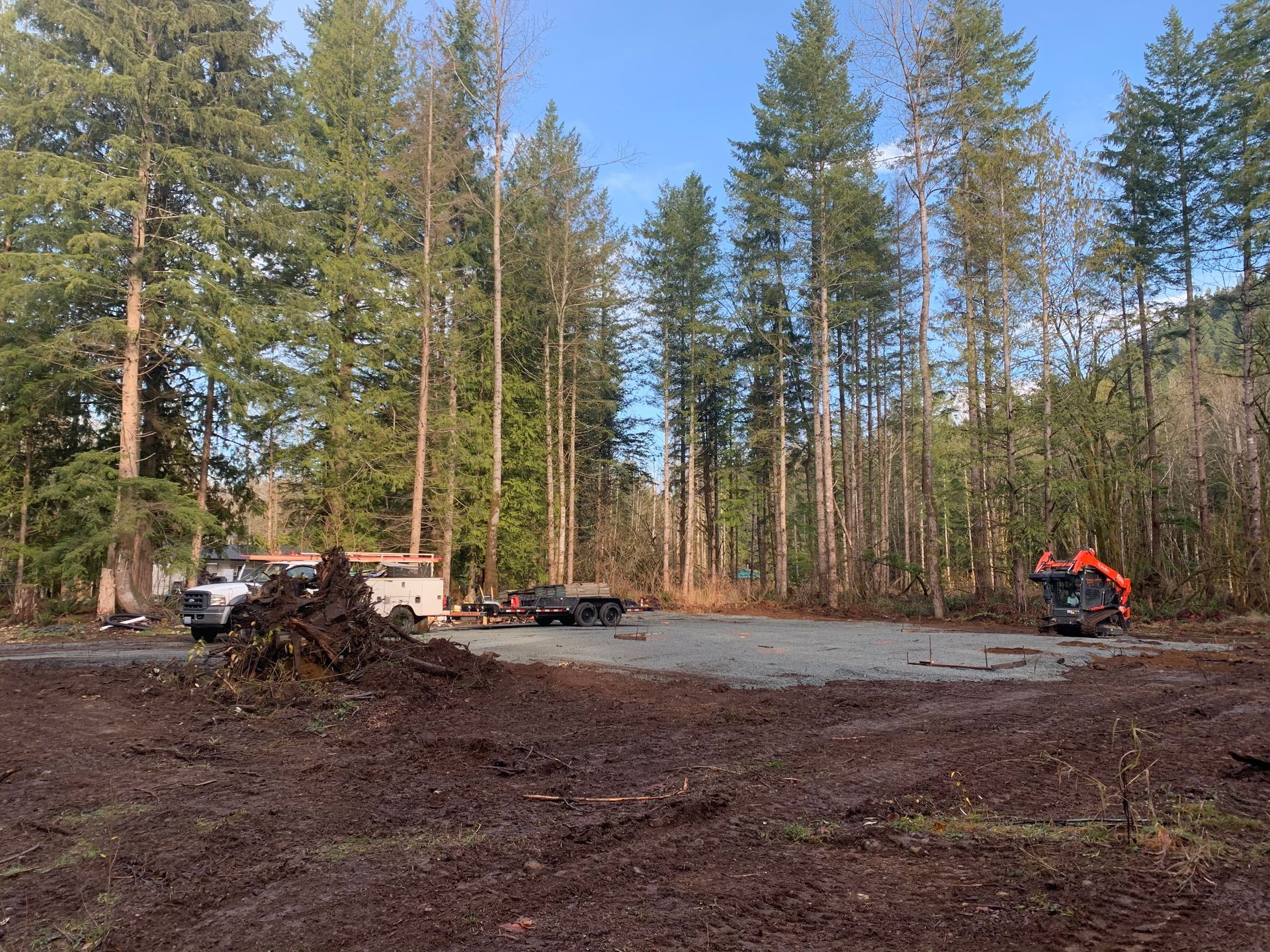 A large piece of concrete is sitting on top of a dirt field.
