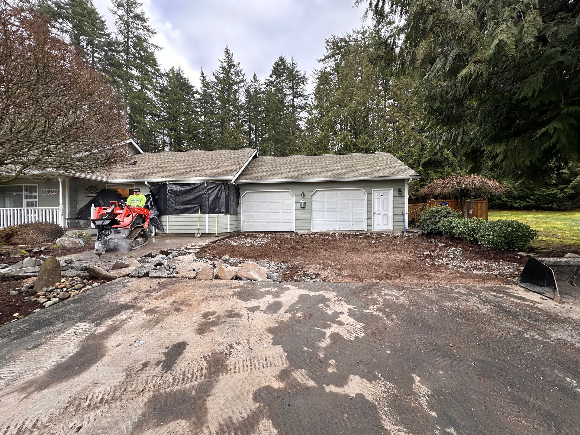 A large concrete slab is sitting on top of a dirt road.