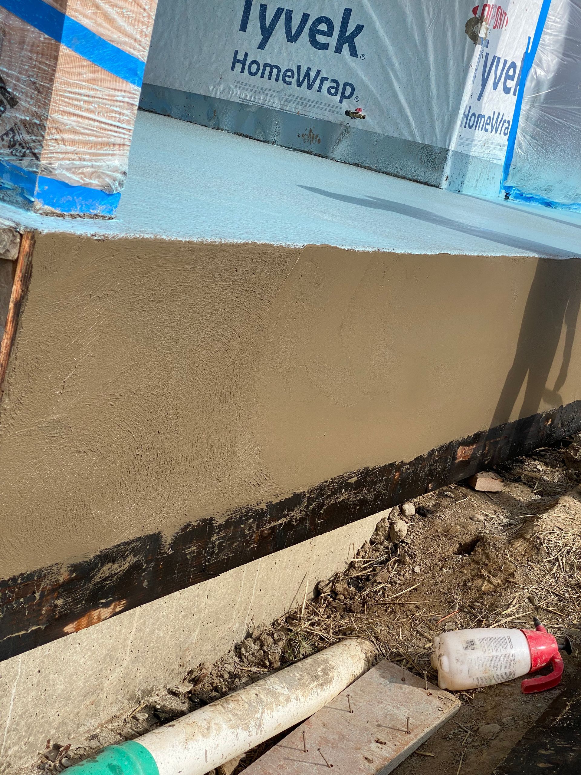 A collage of two pictures of a concrete wall being built.