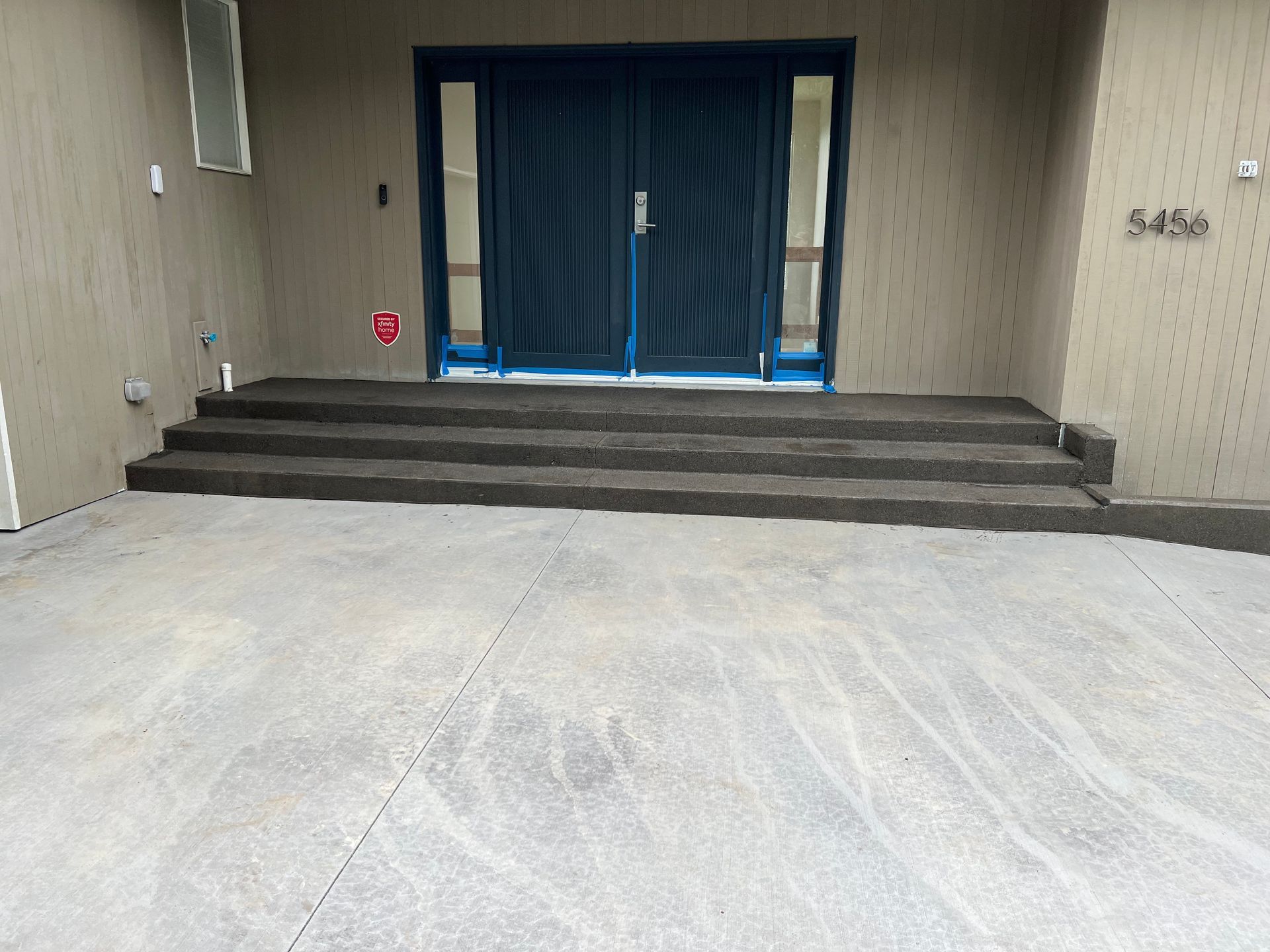 A building with a blue door and steps leading to it